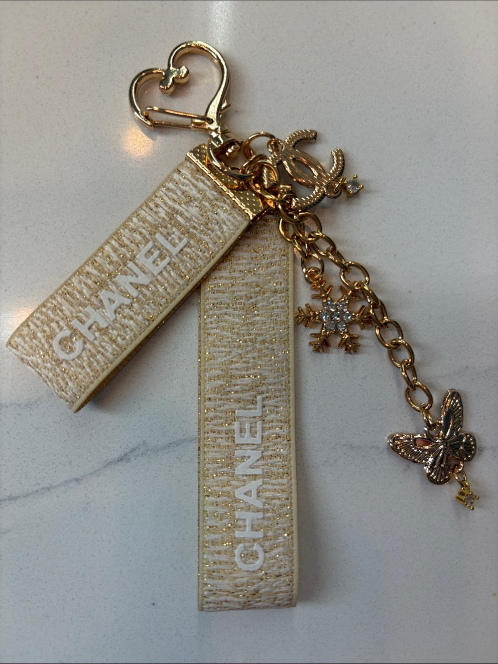 Beige and Gold Logo Strap Keychain with Charms